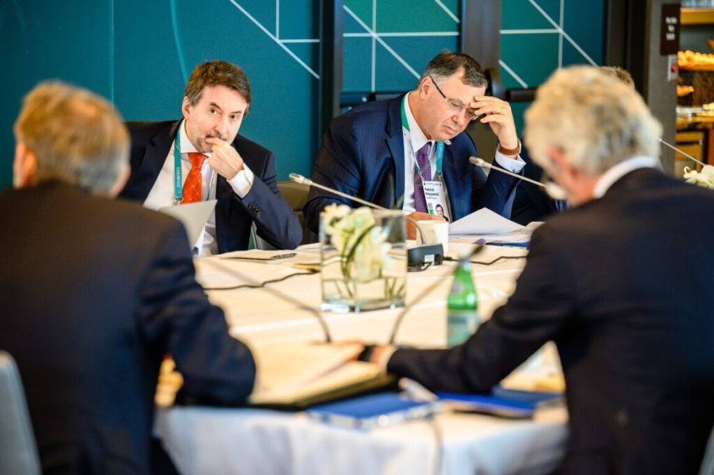 Josu Jon Imaz, CEO of Repsol S.A., and Patrick Pouyanné, CEO of TotalEnergies SE, looking pensive during a meeting.