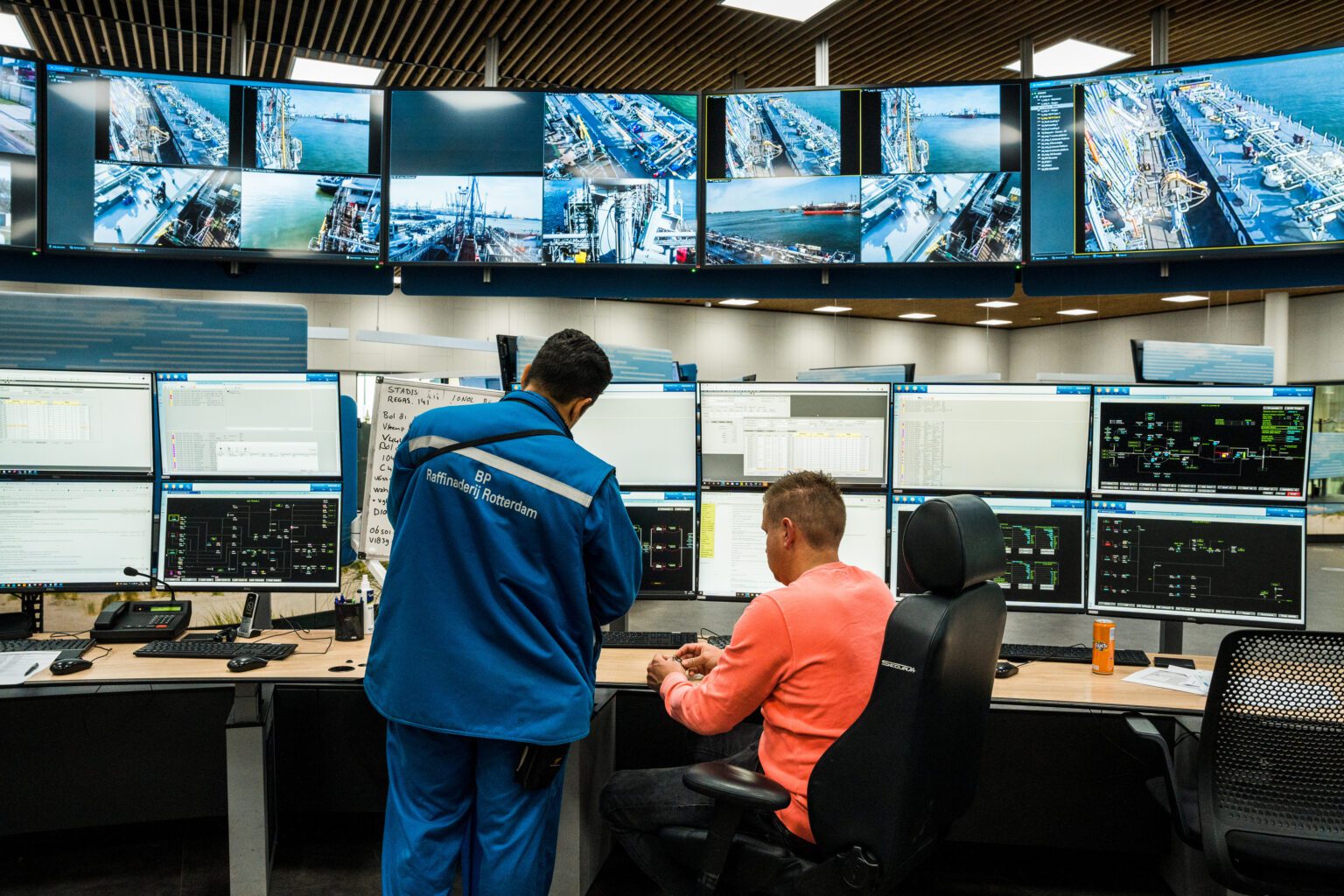 Two engineers at a refinery monitoring real life systems