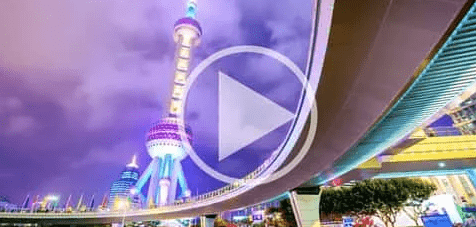 A front cover of a video with multicoloured sky scrapers rising into a purple sky.