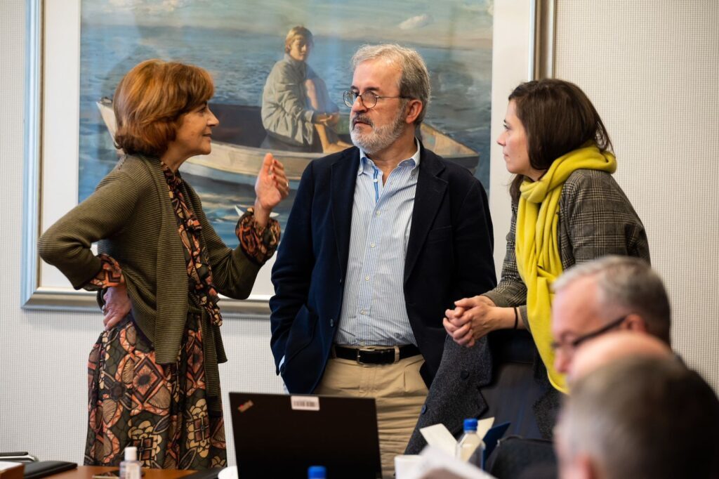 Some members of the Executive Committee having a discussion at a meeting