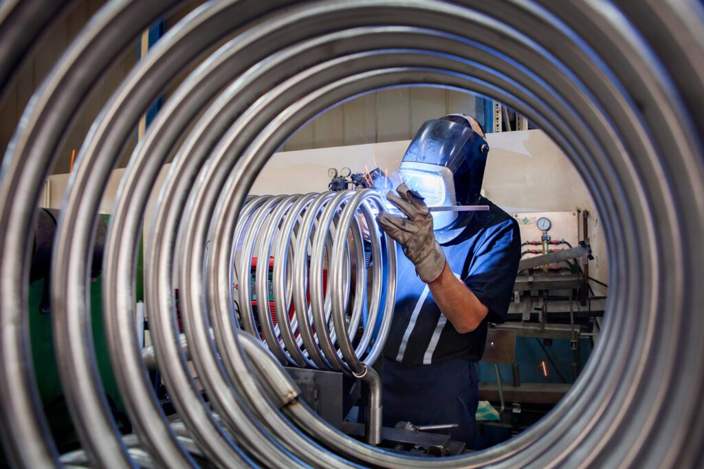 Engineer working on coiled pipe