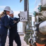 Two engineers working on an oil field