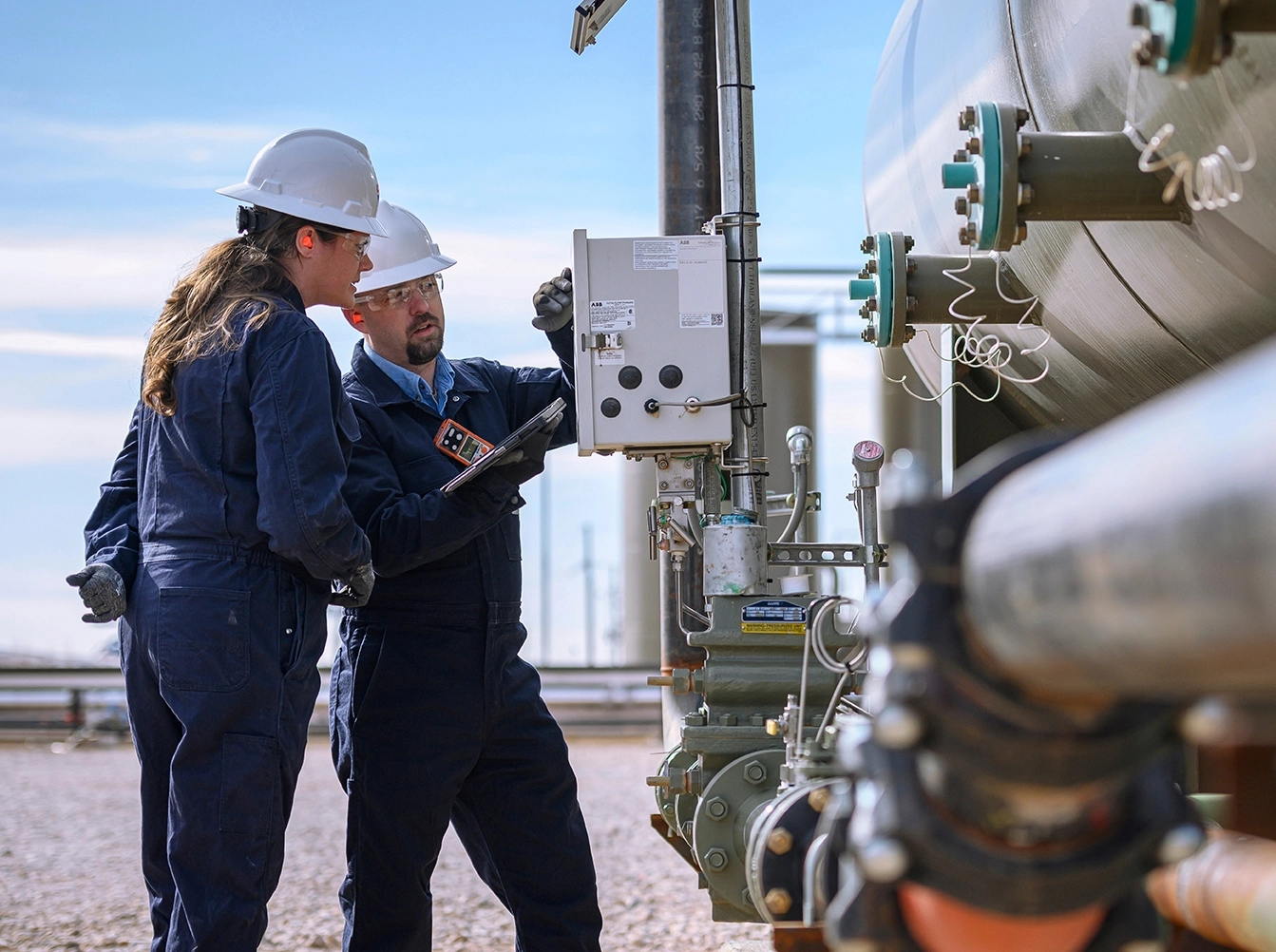 Two engineers working on an oil field