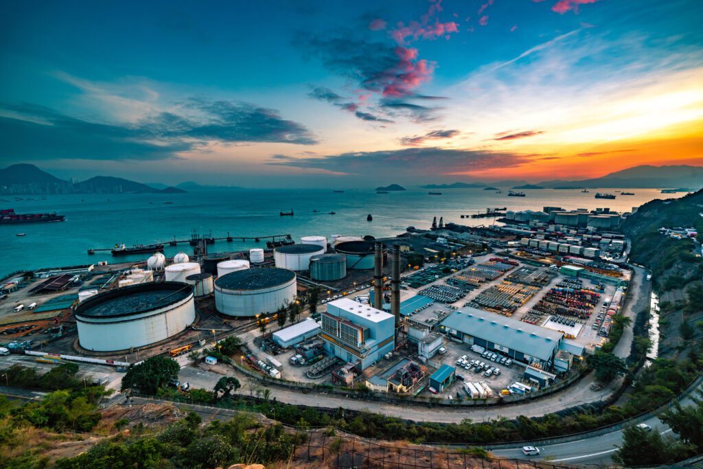 The tank is in the light of the industrial area. With the sky of the sunset.