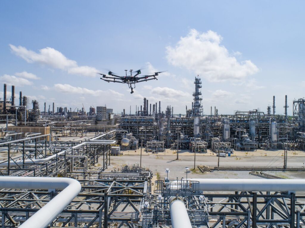 A drone flying over an oil field facility.