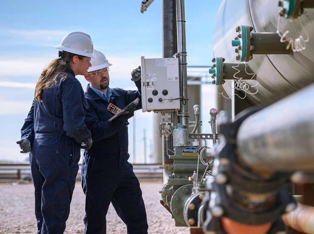 Two engineers working on an oil field