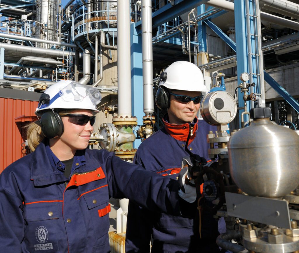 A female and male oil refinery engineer working on site.