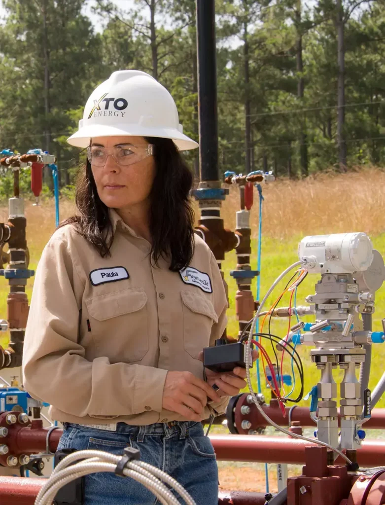 A female engineer working at an oil field.