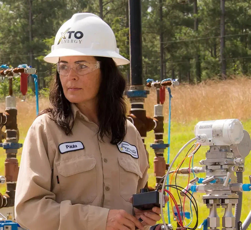 A female engineer working at an oil field.