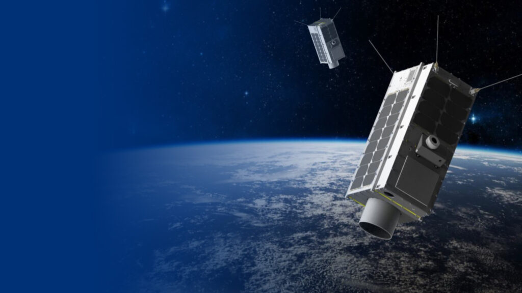 GHG Satellites in space with the world viewed below them. Blue gradient to the left of the image.